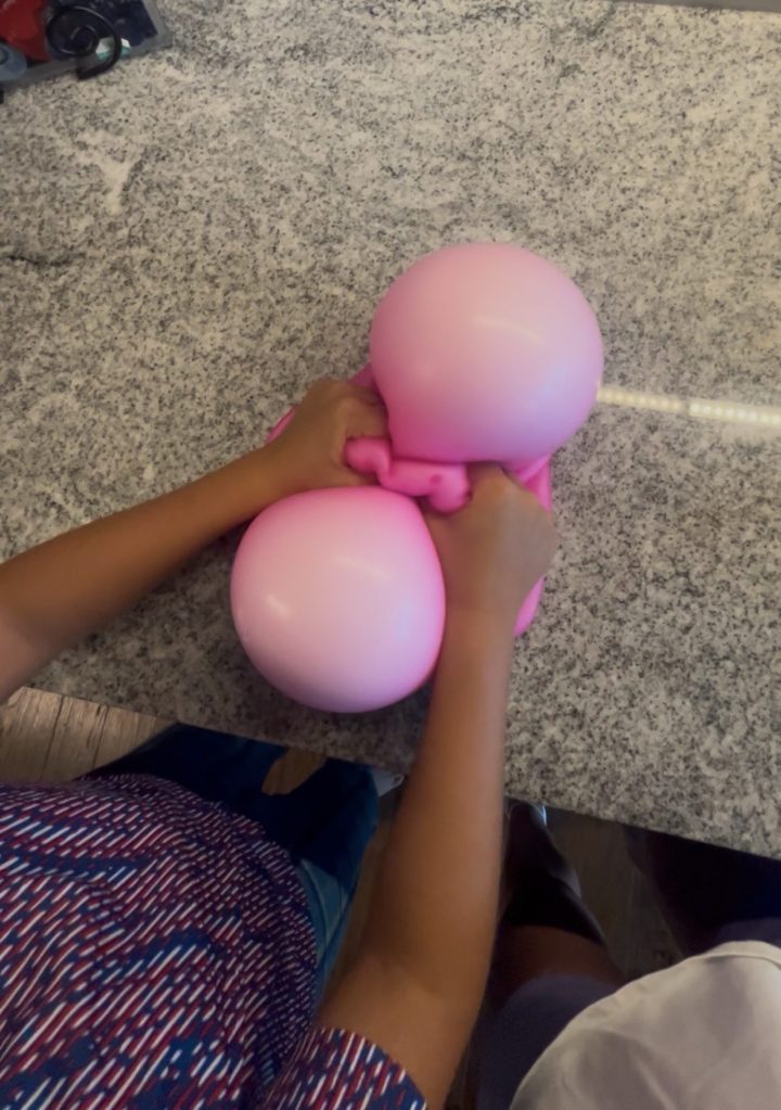 DIY Giant Squishy Toy for Kids - photo of two hands molding the pink squishy toy