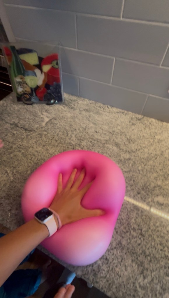DIY Giant Squishy Toy for Kids - photo of a child squeezing a pink Wubble squishy toy